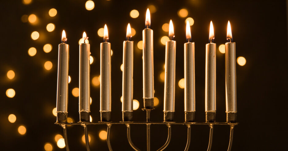 menorah-with-candles-near-abstract-garland-lights-3-940x493